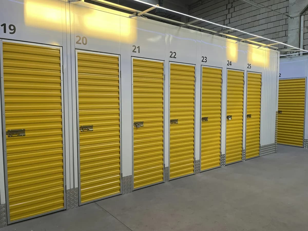 Row of storage units with yellow roll-up doors