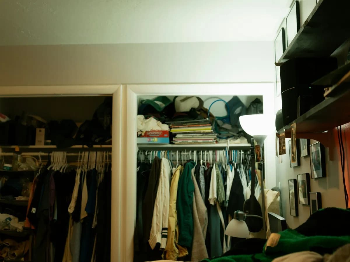 An open closet full of clothes on hangers